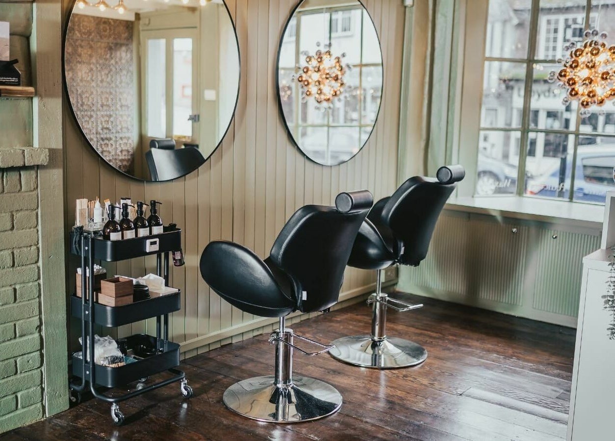 Elegant salon chairs at The Foundry, Cranbrook, England, GB, with stylish mirrors and ambient lighting.