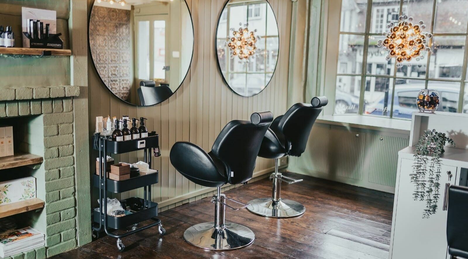 Elegant salon chairs at The Foundry, Cranbrook, England, GB, with stylish mirrors and ambient lighting.