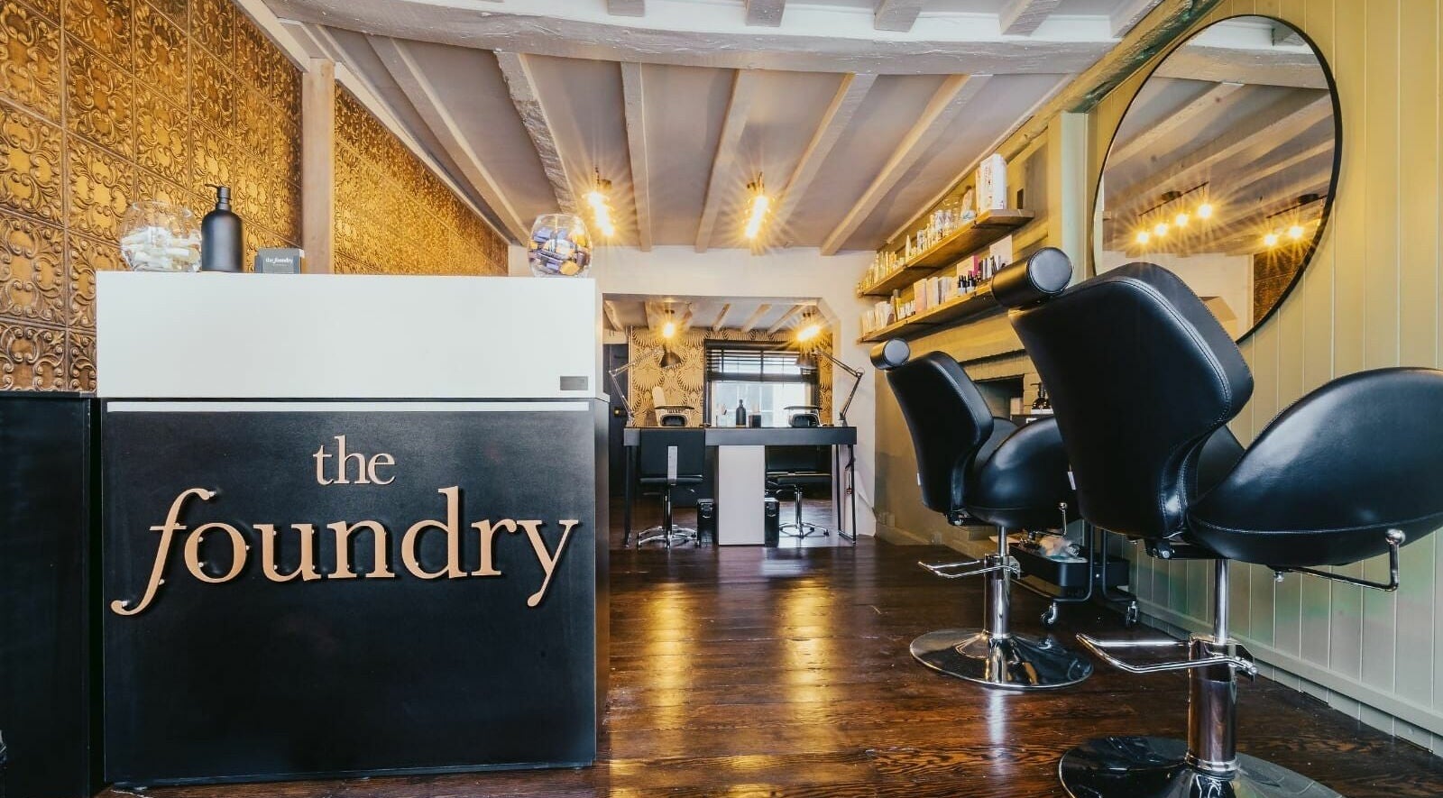 Stylish interior of The Foundry salon in Cranbrook, England featuring modern chairs and decor.