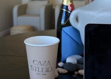 Elegant CAZA STUDIO setup with coffee, laptop, and champagne in Mont-royal, Québec, CA.