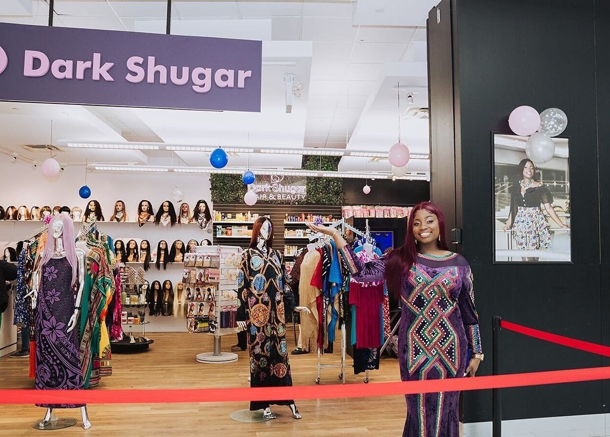 Entrance of Dark Shugar Hair & Beauty Studios, St Vital with colorful wigs and dresses, Winnipeg, Manitoba, CA.