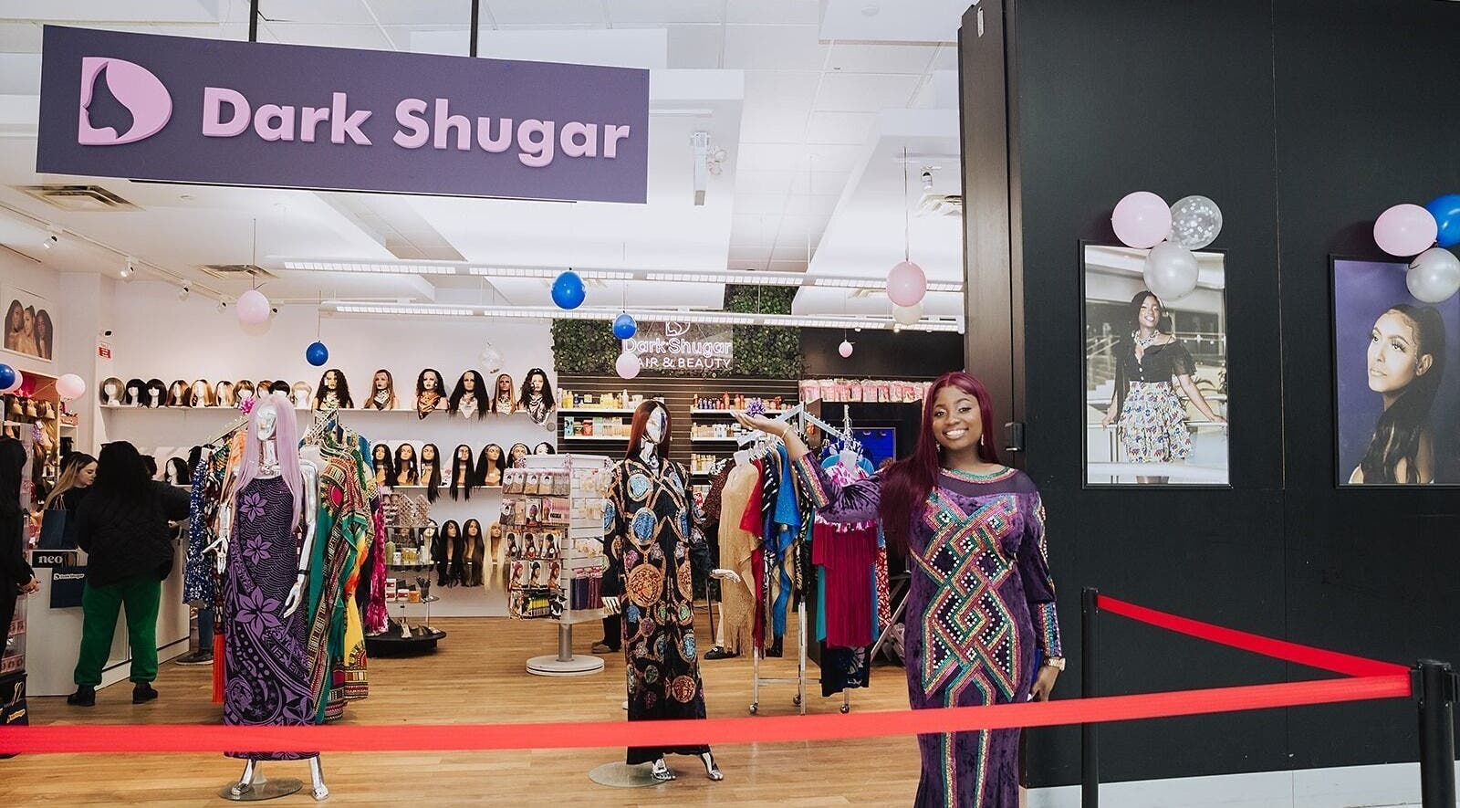 Entrance of Dark Shugar Hair & Beauty Studios, St Vital with colorful wigs and dresses, Winnipeg, Manitoba, CA.