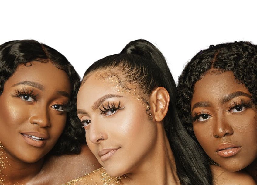 Three women with glowing makeup at Dark Shugar Hair & Beauty Studios, St Vital, Winnipeg, Manitoba, CA.