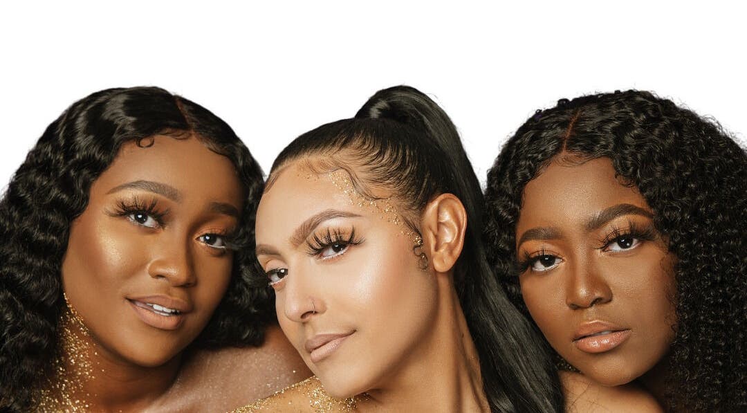 Three women with glowing makeup at Dark Shugar Hair & Beauty Studios, St Vital, Winnipeg, Manitoba, CA.