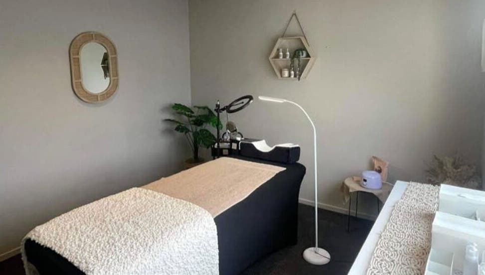 Tranquil spa room at Mason & May, Christchurch, Canterbury, NZ, featuring a massage table and serene decor.