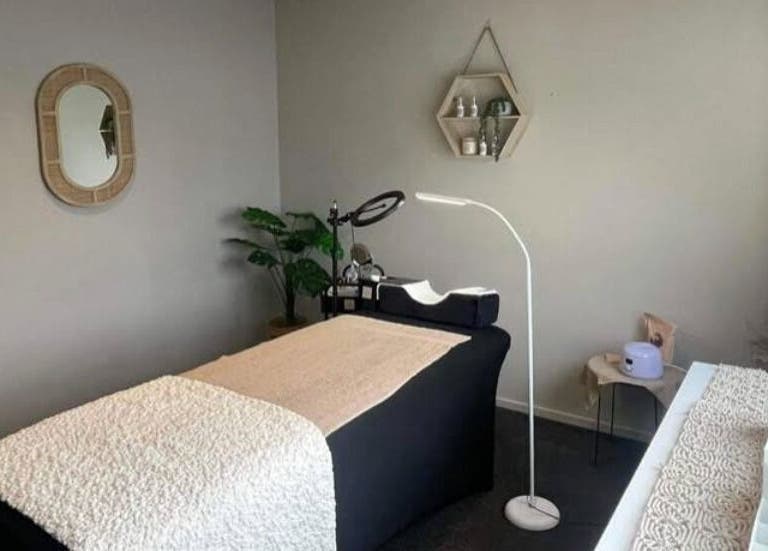 Tranquil spa room at Mason & May, Christchurch, Canterbury, NZ, featuring a massage table and serene decor.