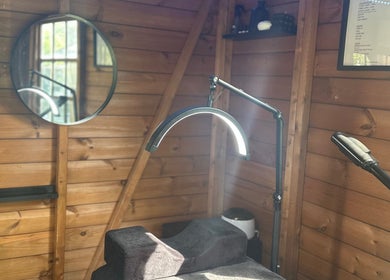 Cozy treatment room at The Beauty Lounge, Wigston, England, GB, featuring a wooden decor and modern equipment.