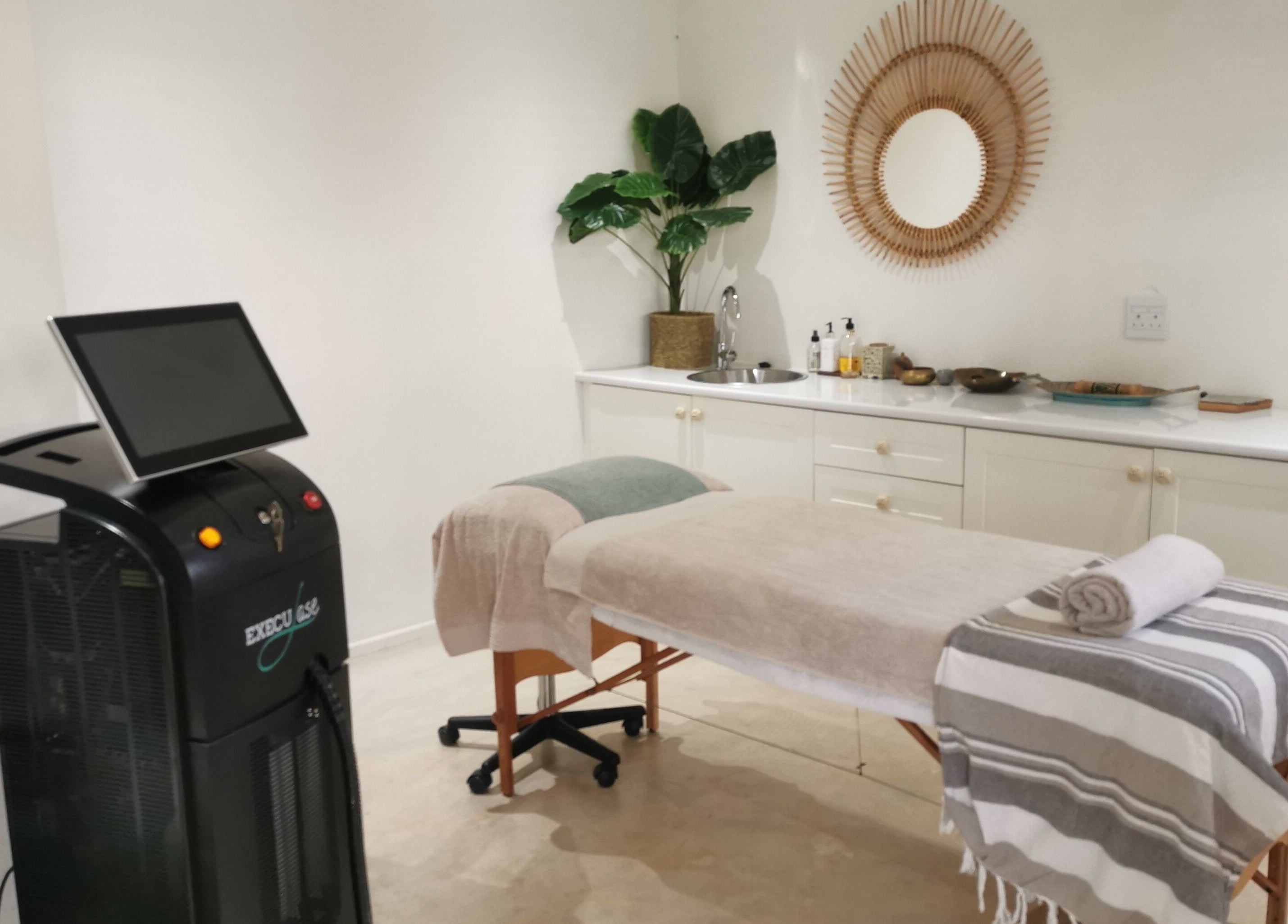 Relaxing treatment room at No Filter Laser and Aesthetics, Sandton, Gauteng, ZA with a modern aesthetic setup.