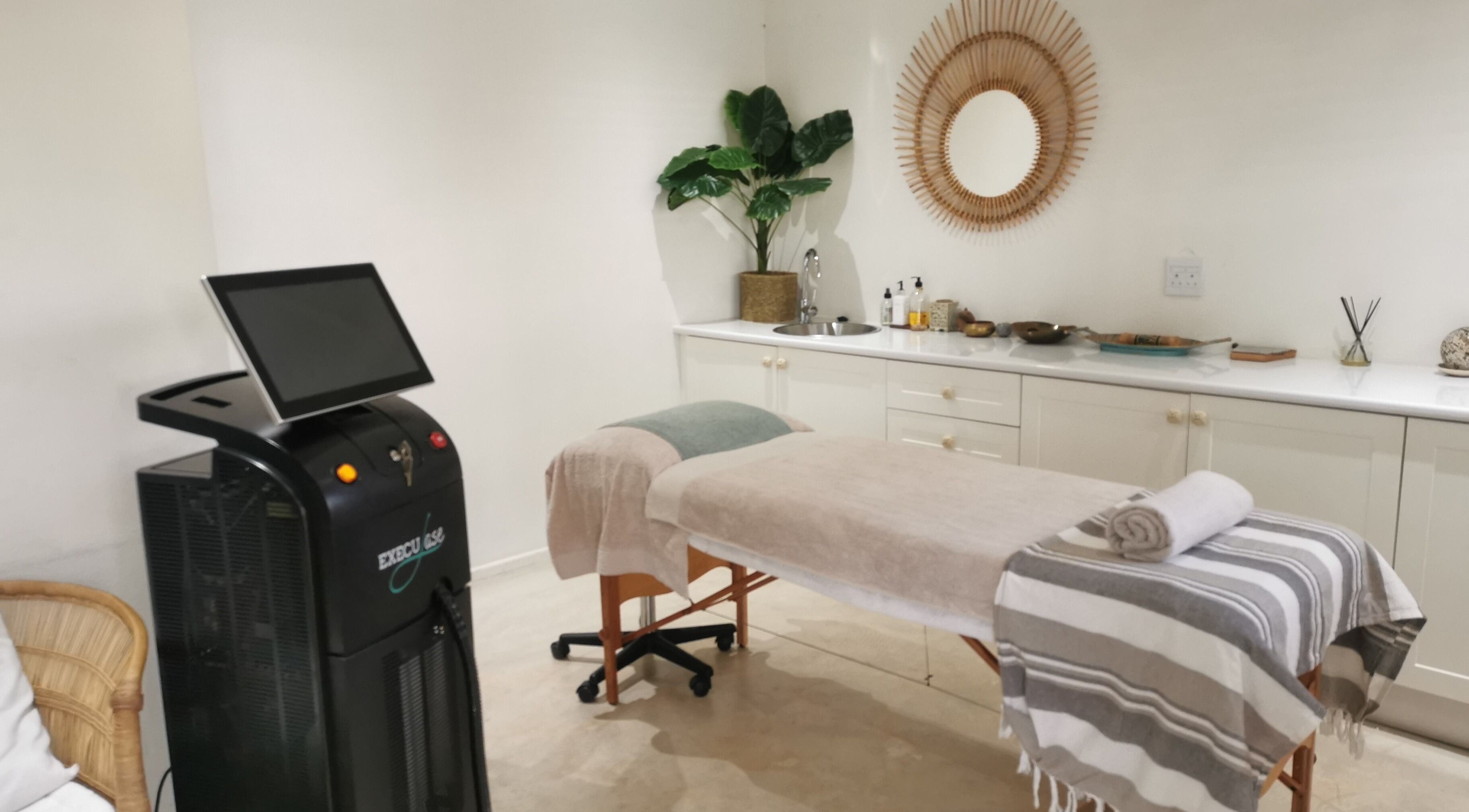 Relaxing treatment room at No Filter Laser and Aesthetics, Sandton, Gauteng, ZA with a modern aesthetic setup.
