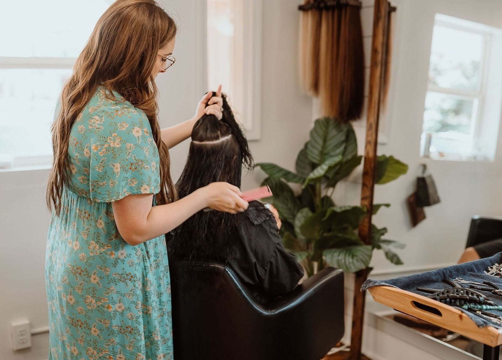 Stylist working on a client's hair at Kyana Britner with Texture+Sage, Fremont, Ohio, US.