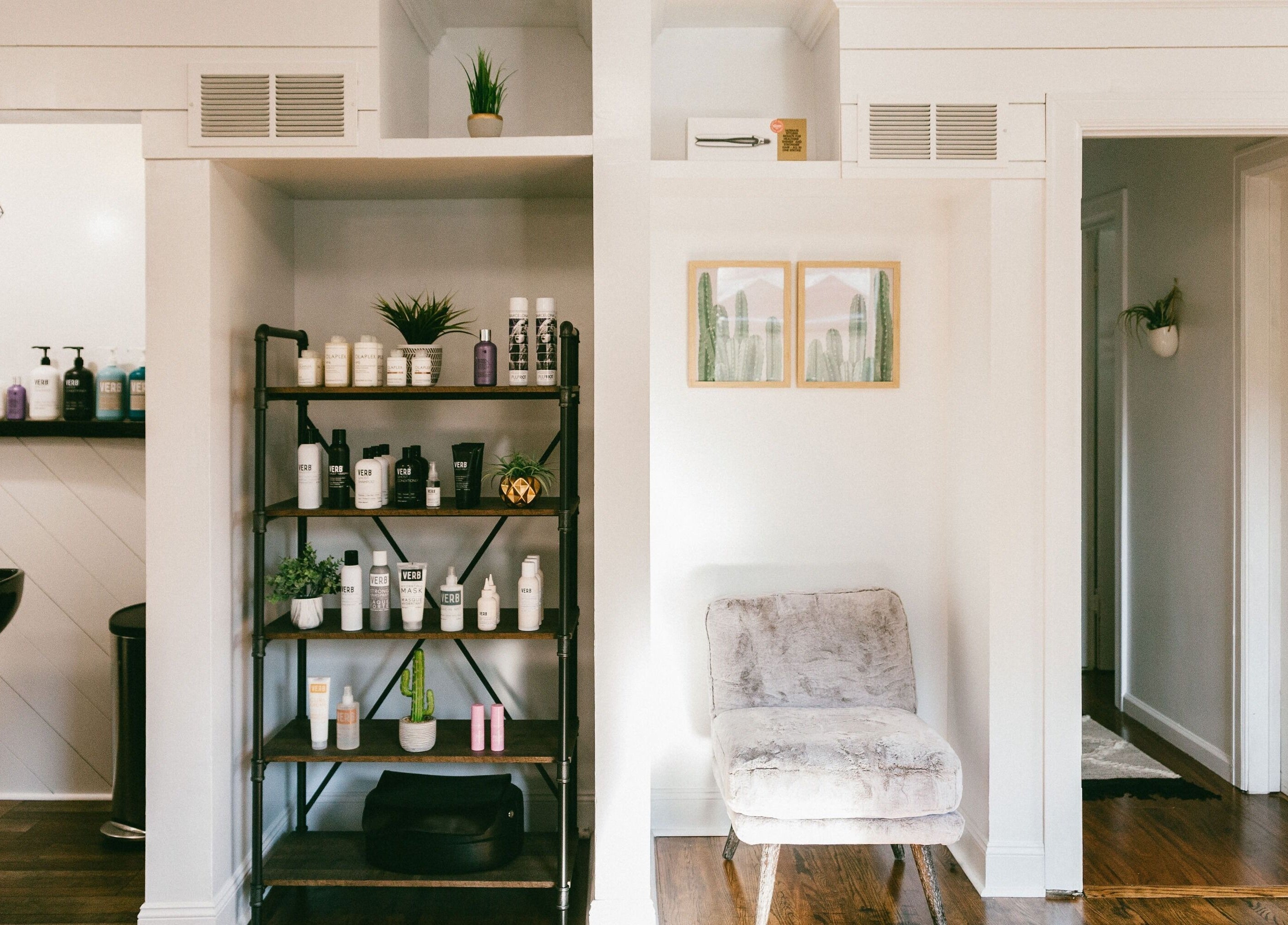 Elegant salon interior at Kyana Britner with Texture+Sage, Fremont, Ohio, US, showcasing product shelves and seating.