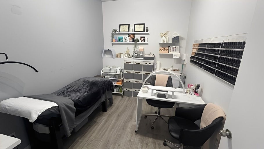 Cozy treatment room at Sugar and Stone Aesthetics in Kingston, Ontario, CA, with a massage bed and beauty products.