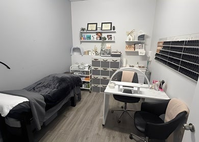 Cozy treatment room at Sugar and Stone Aesthetics in Kingston, Ontario, CA, with a massage bed and beauty products.