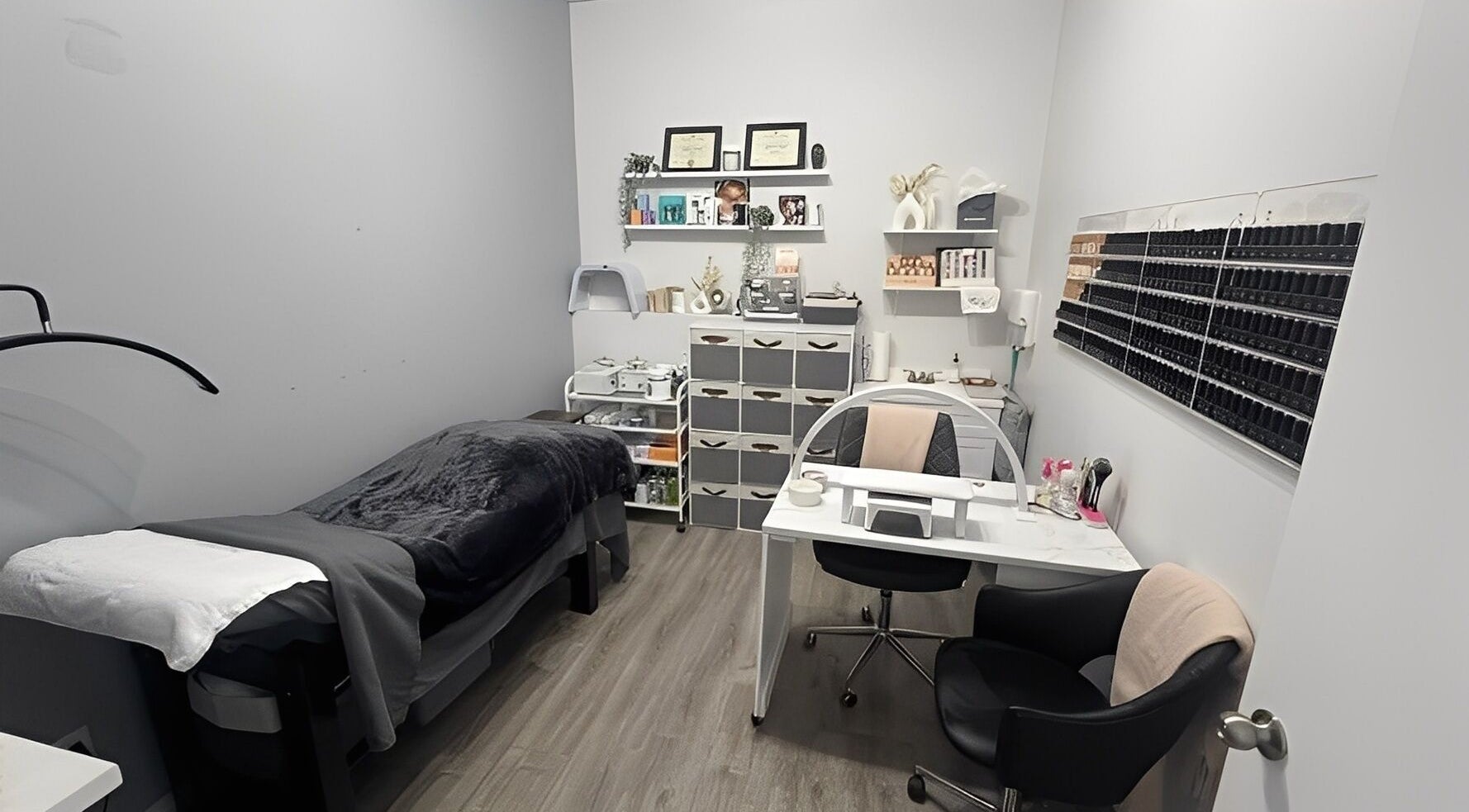Cozy treatment room at Sugar and Stone Aesthetics in Kingston, Ontario, CA, with a massage bed and beauty products.