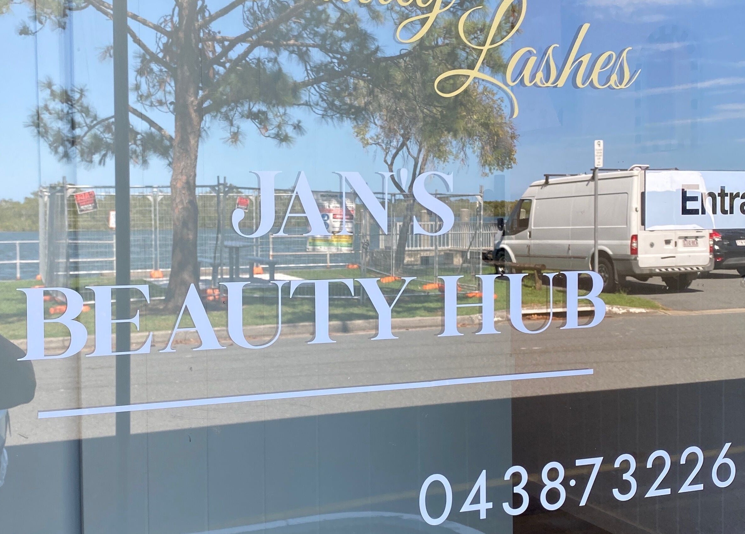 Entrance of Jan's Beauty Hub at Hope Island, Queensland, AU, highlighted with clear glass signage.