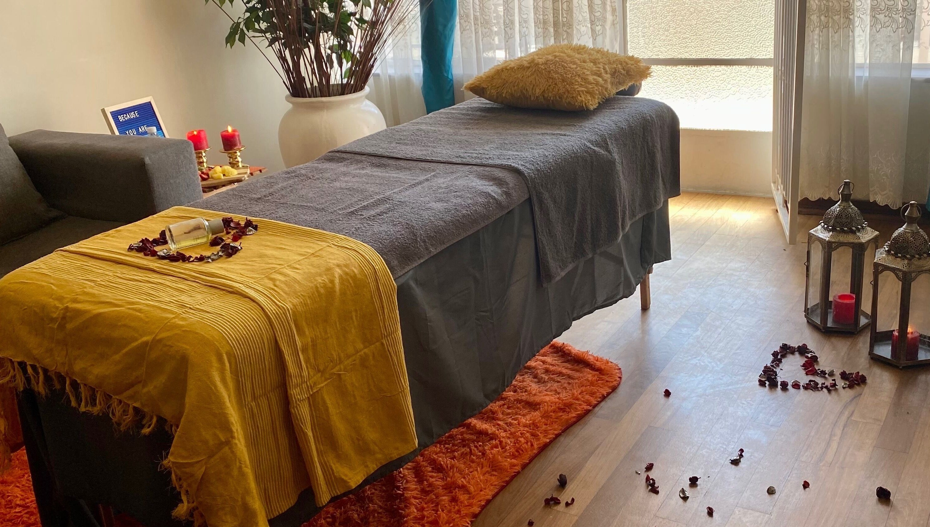 Relaxing spa setup at Browed by Pat, Johannesburg, Gauteng, ZA with candles and cozy massage table.
