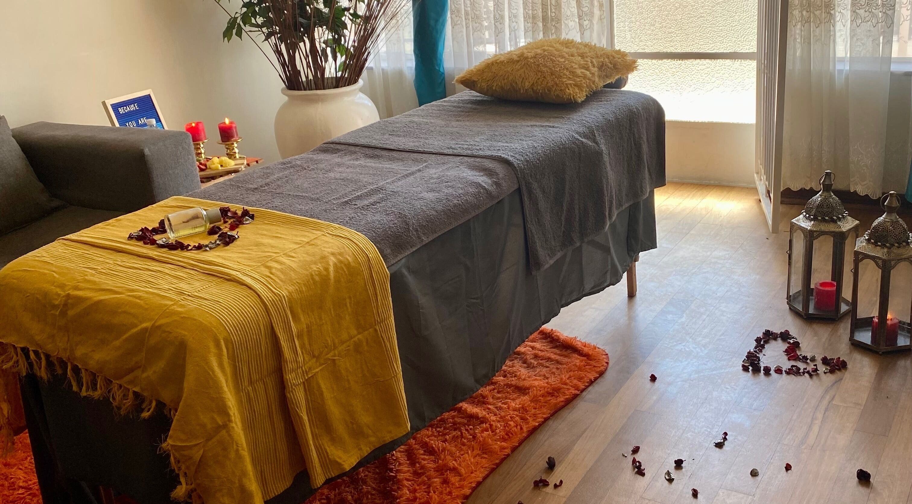 Relaxing spa setup at Browed by Pat, Johannesburg, Gauteng, ZA with candles and cozy massage table.