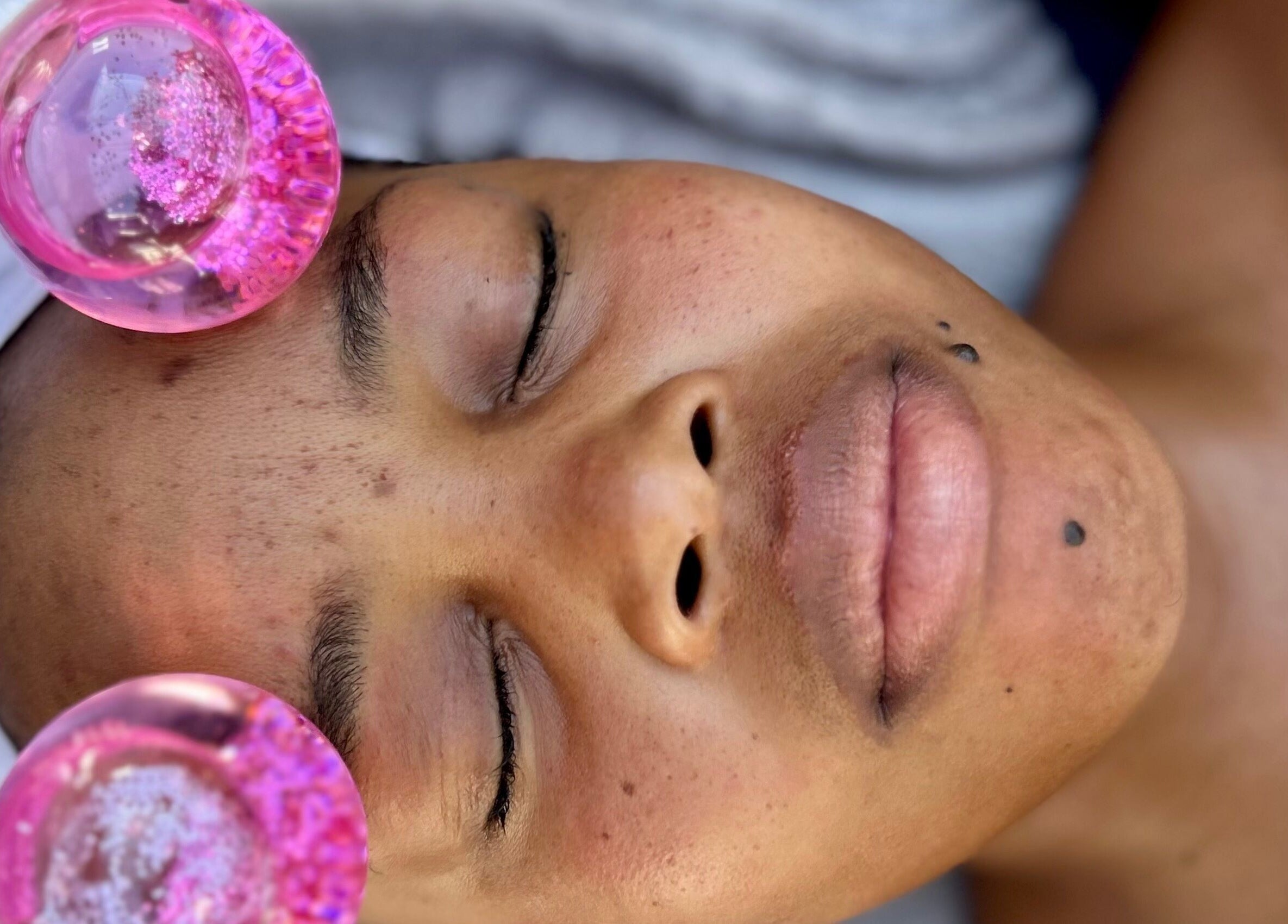 Relaxing facial massage with pink therapy spheres at Browed by Pat, Johannesburg, Gauteng, ZA.