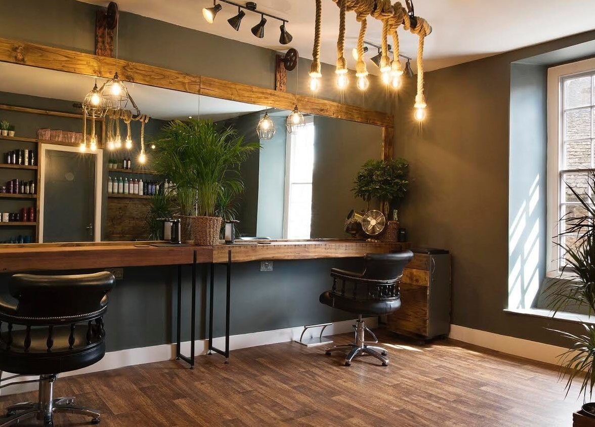 Stylish interior of Karoliina Saunders_Hair salon in Highworth, England, GB showcasing elegant decor and seating.