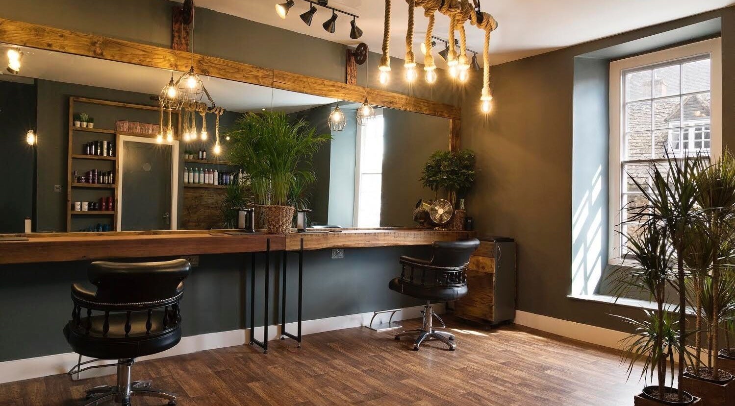 Stylish interior of Karoliina Saunders_Hair salon in Highworth, England, GB showcasing elegant decor and seating.