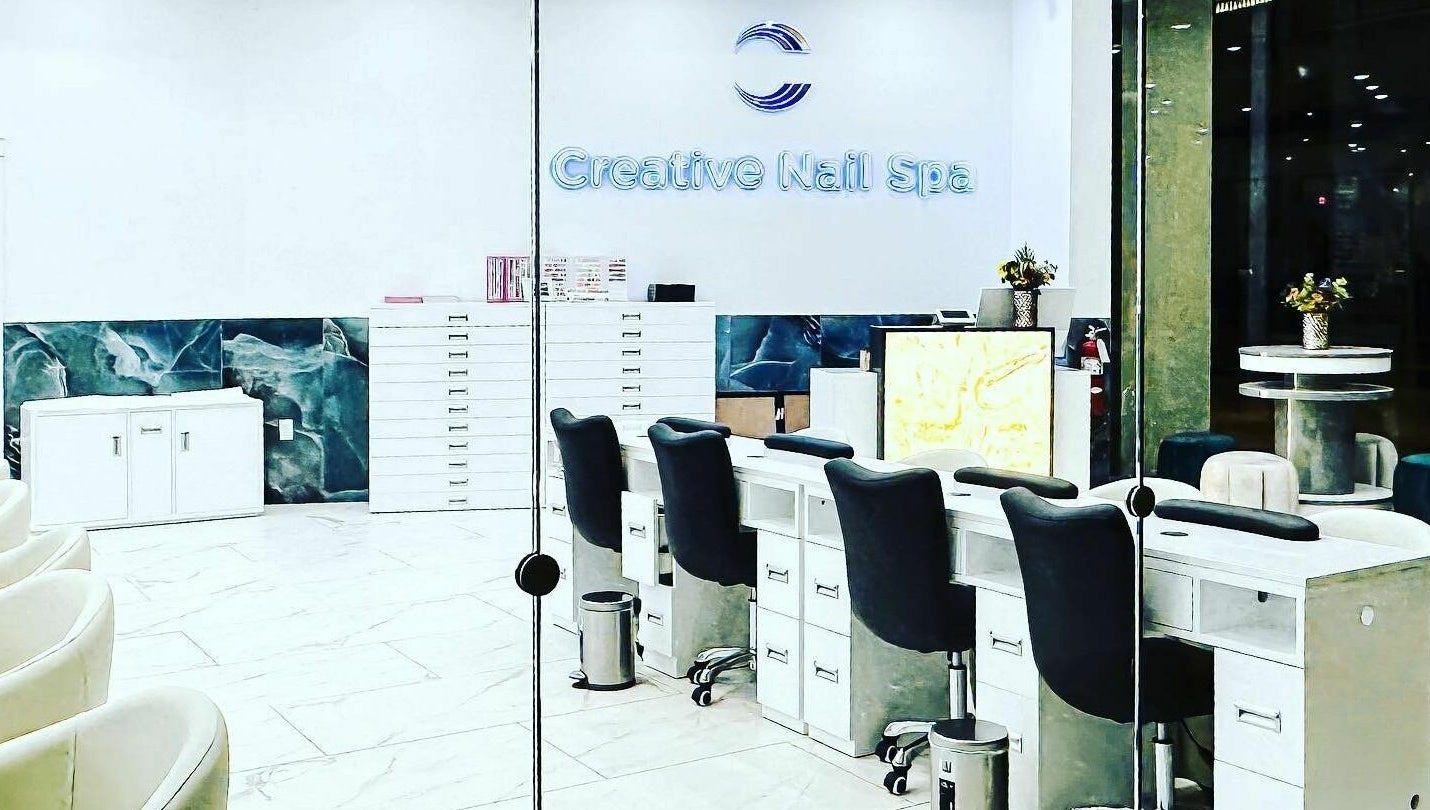 Bright interior of Creative Nail Spa showcasing modern nail stations in West Des Moines, Iowa, US.