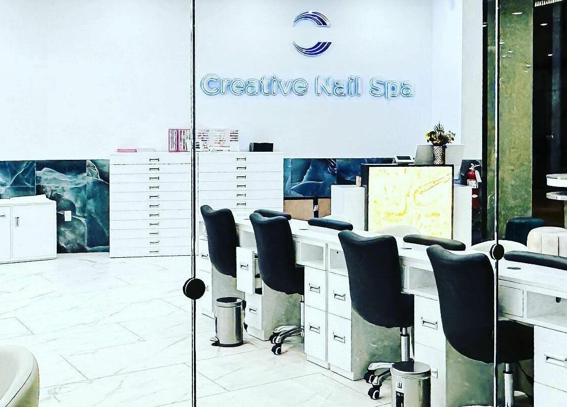 Bright interior of Creative Nail Spa showcasing modern nail stations in West Des Moines, Iowa, US.