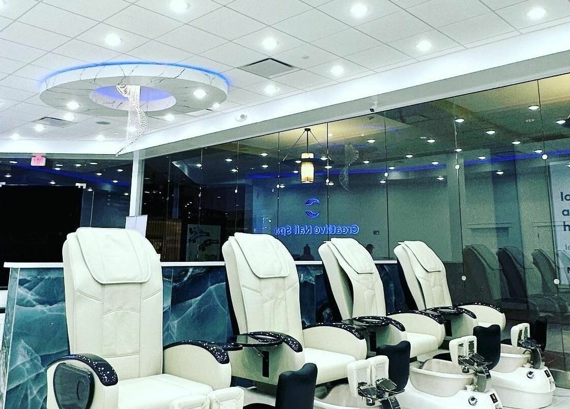 Luxurious pedicure chairs at Creative Nail Spa in West Des Moines, Iowa, US under soft ceiling lights.