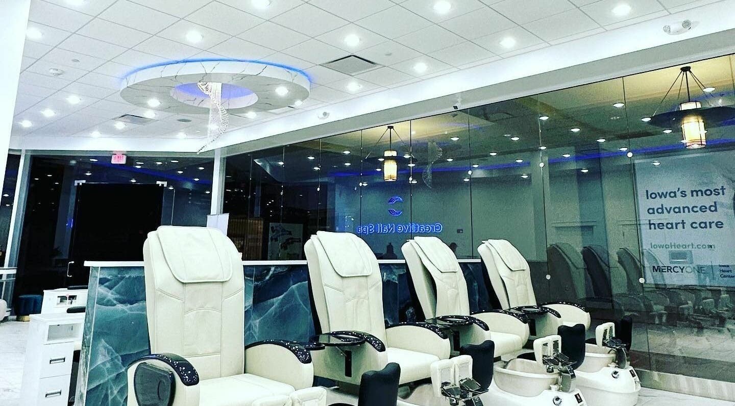 Luxurious pedicure chairs at Creative Nail Spa in West Des Moines, Iowa, US under soft ceiling lights.