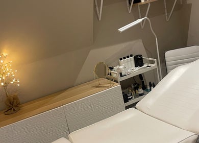 Cozy treatment room at The Beauty Cottage, Almondbury, England, GB, featuring a white spa bed and calming decor.
