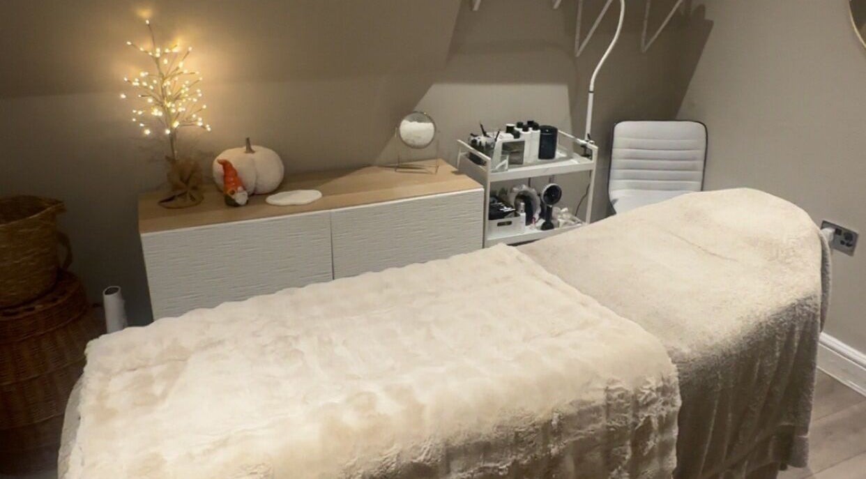 Cozy massage room at The Beauty Cottage in Almondbury, England, GB with soft lighting and plush decor.