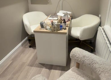 Intimate beauty consultation space at The Beauty Cottage, Almondbury, England, GB with plush chairs and decor.