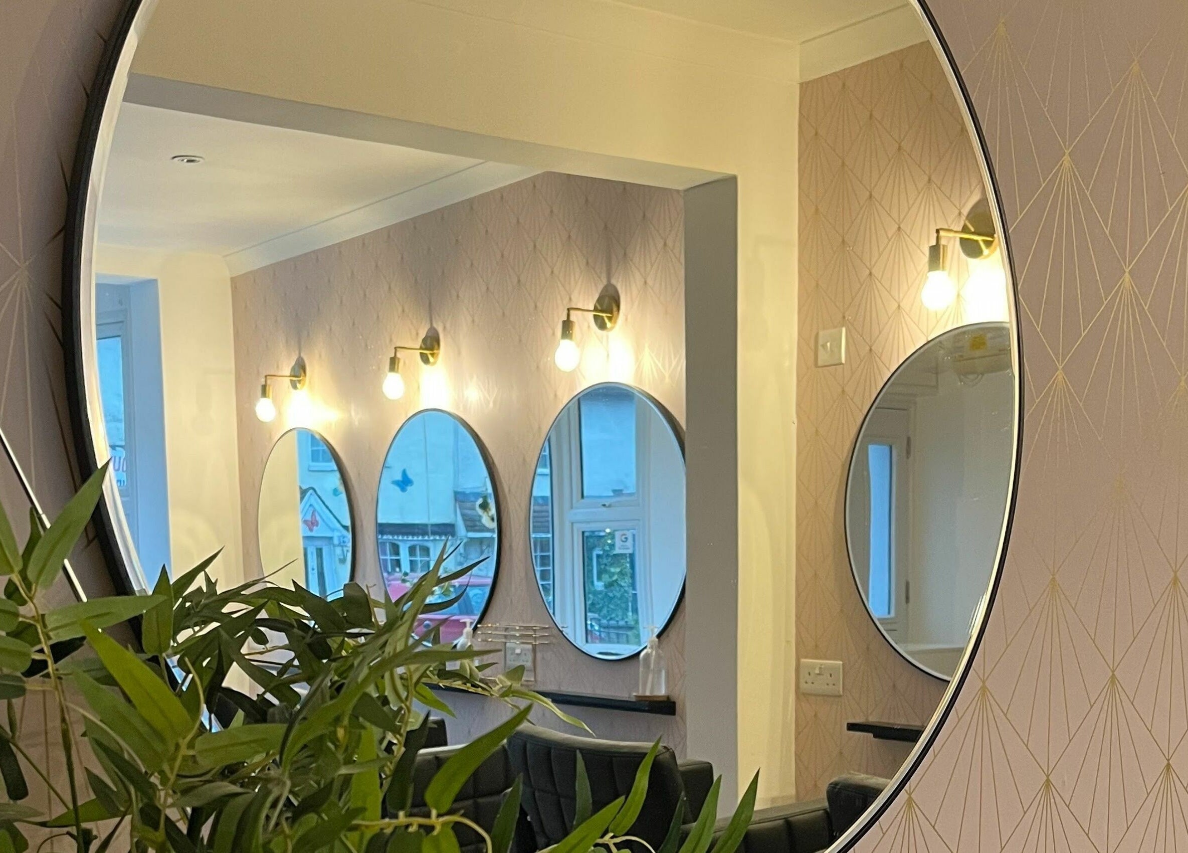 Stylish mirrors and lighting in Salon at 8, Wroughton, England, GB, enhance the ambiance with modern elegance.