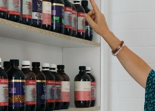 A person selects herbal product at Bodhifit Studio & Wellness, Fyshwick, Australian Capital Territory, AU.
