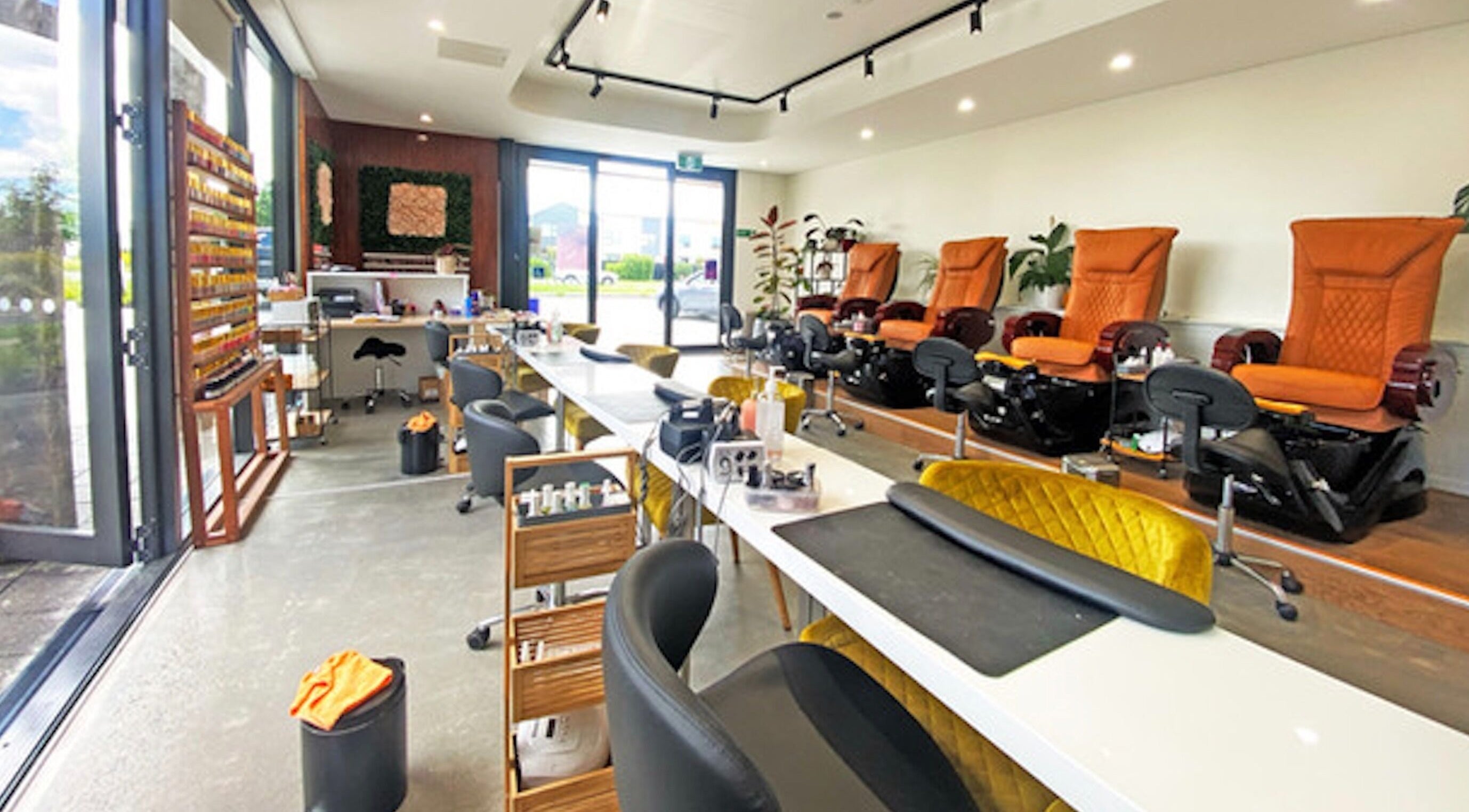 Interior of Bella Signature Nails in Auckland, NZ showcasing cozy manicure and pedicure stations.