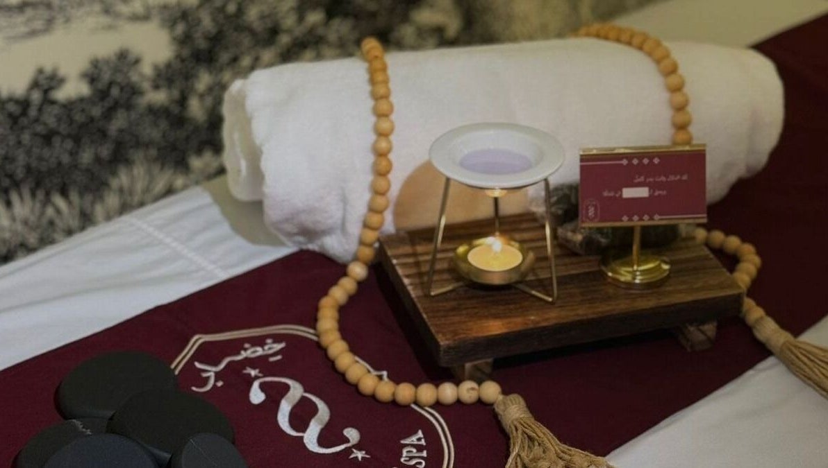 Relaxing spa setup at Ghumra I غمرة, Dhahran, Eastern Province, SA, featuring towels and candles.