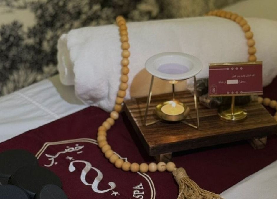 Relaxing spa setup at Ghumra I غمرة, Dhahran, Eastern Province, SA, featuring towels and candles.
