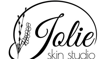 Jolie Skin Studio logo featuring elegant floral design, Austin, Texas, US.