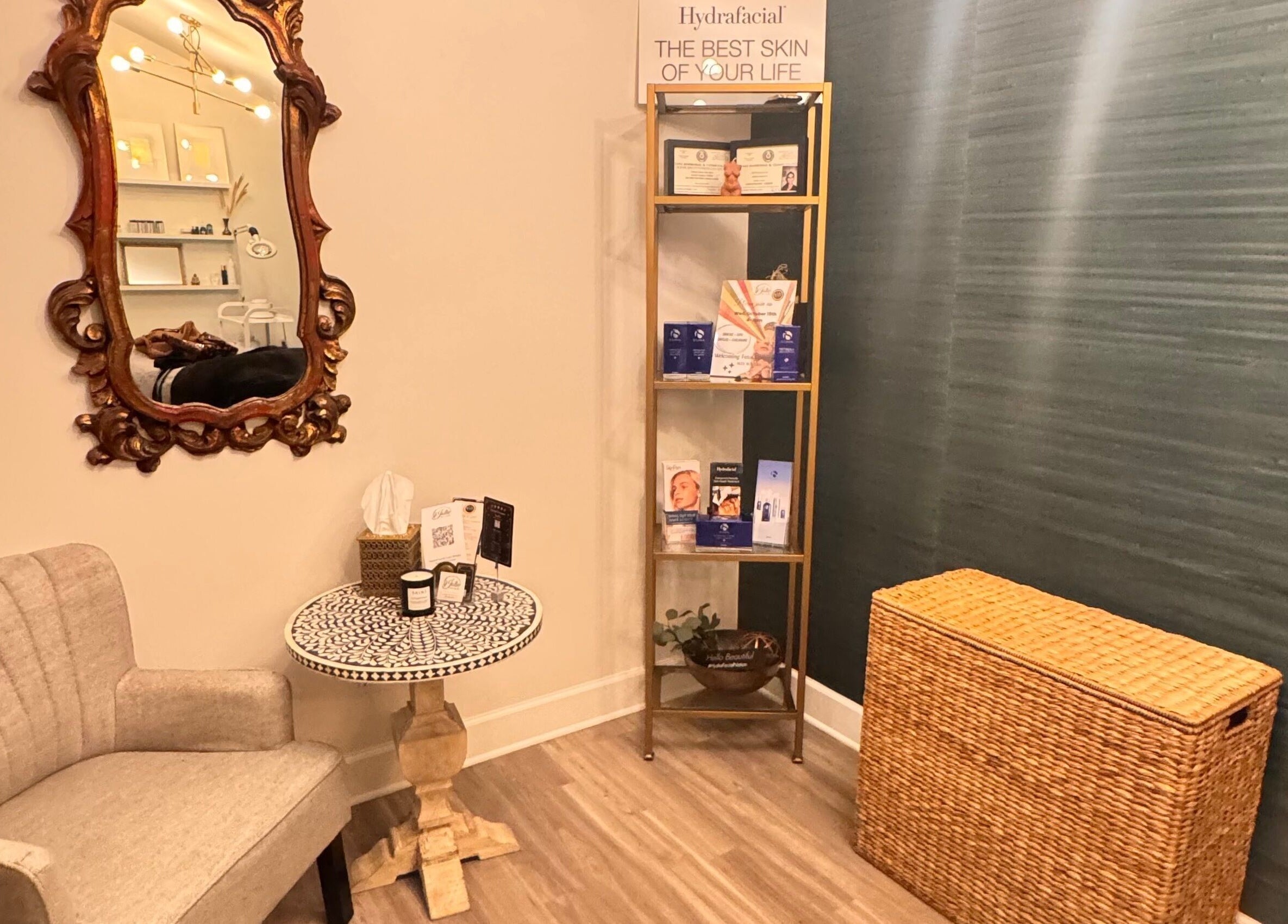 Cozy corner at Jolie Skin Studio, Austin, Texas, US, with ornate mirror and chic seating.