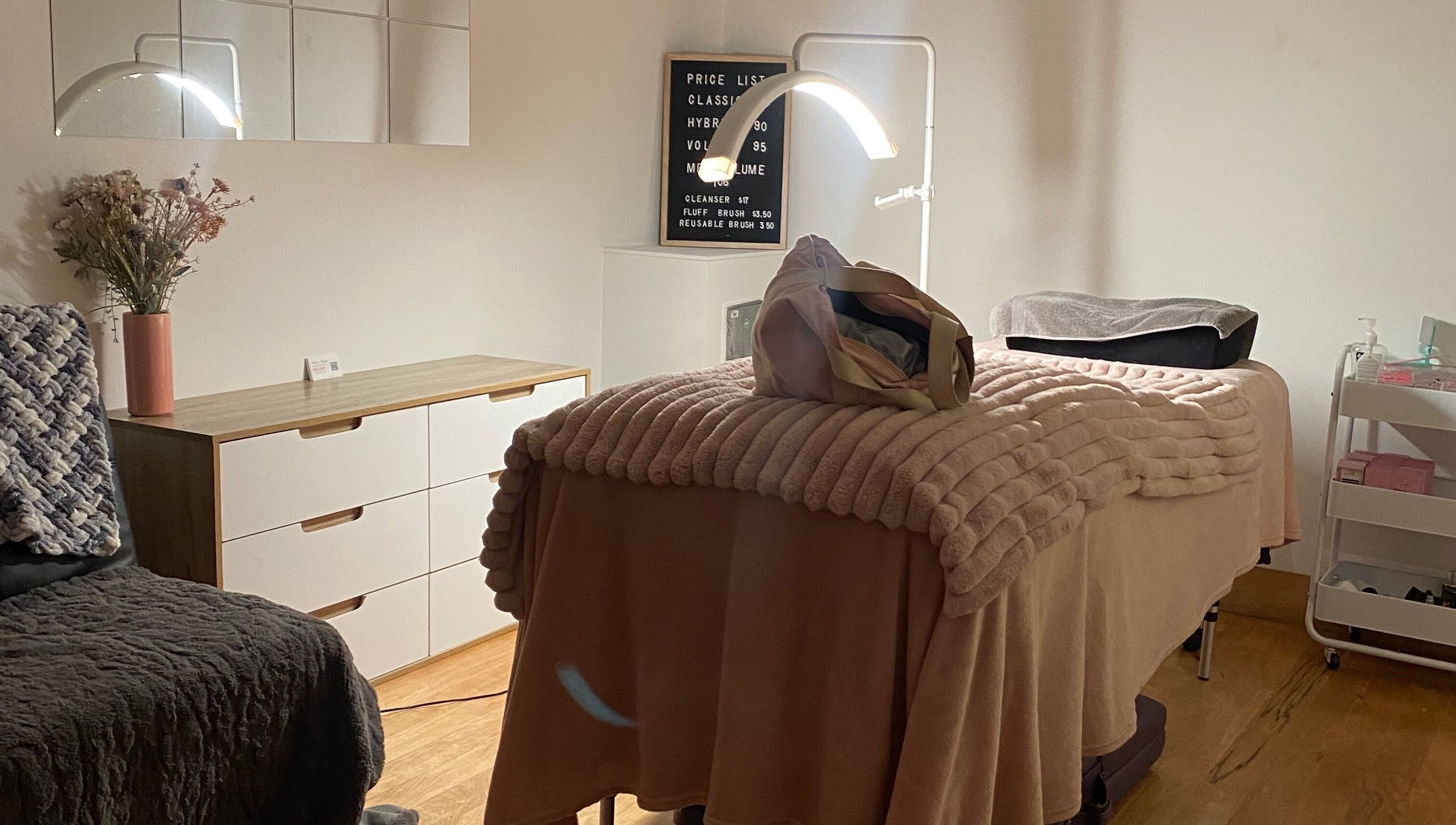 Cozy treatment room at Lush Lash Ariana, Kapiti, Wellington, NZ, featuring a plush bed and stylish decor.