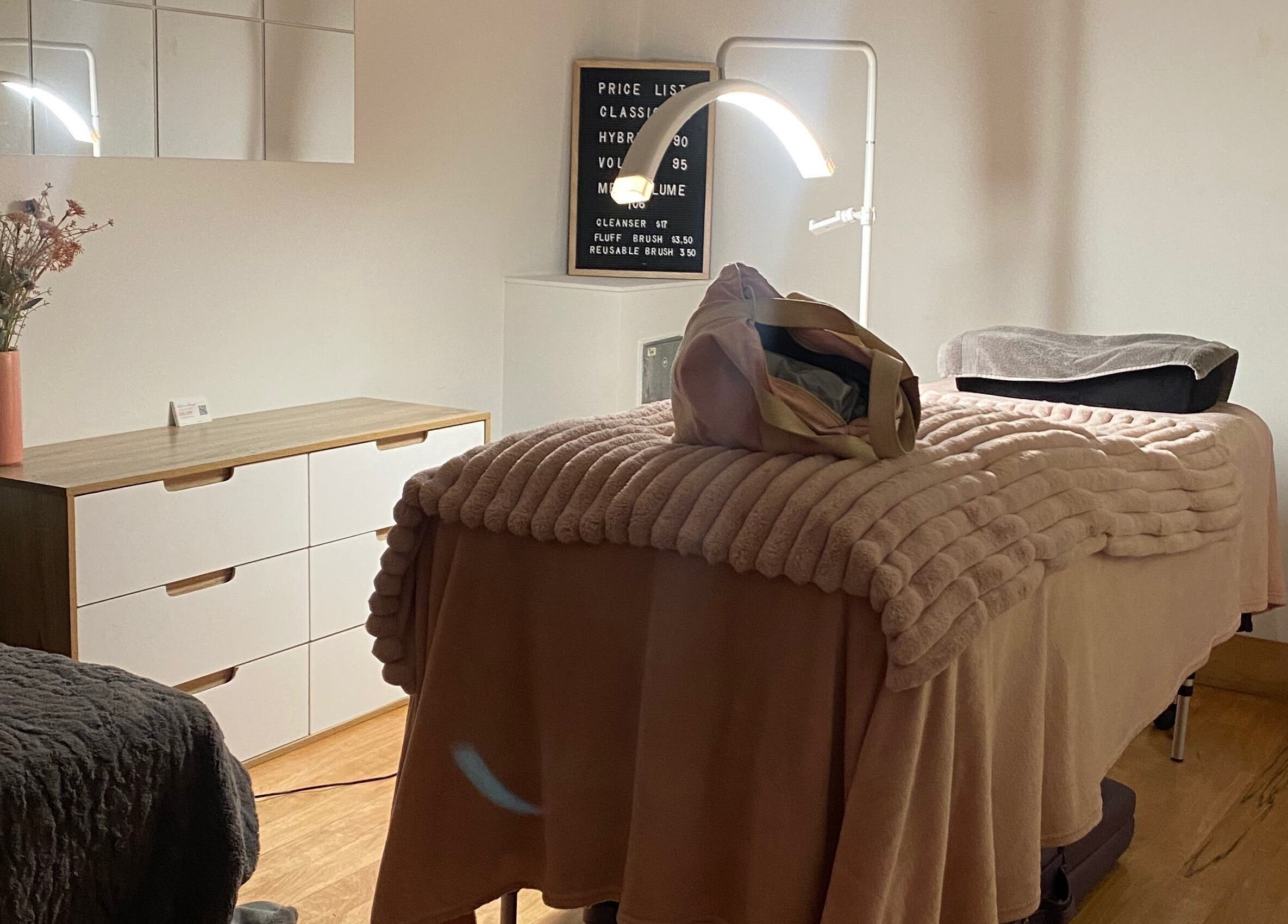 Cozy treatment room at Lush Lash Ariana, Kapiti, Wellington, NZ, featuring a plush bed and stylish decor.