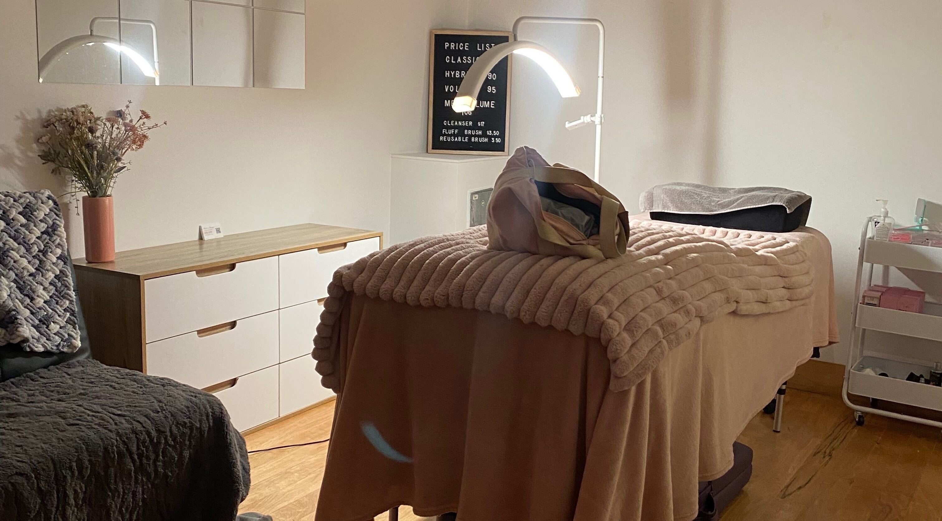 Cozy treatment room at Lush Lash Ariana, Kapiti, Wellington, NZ, featuring a plush bed and stylish decor.