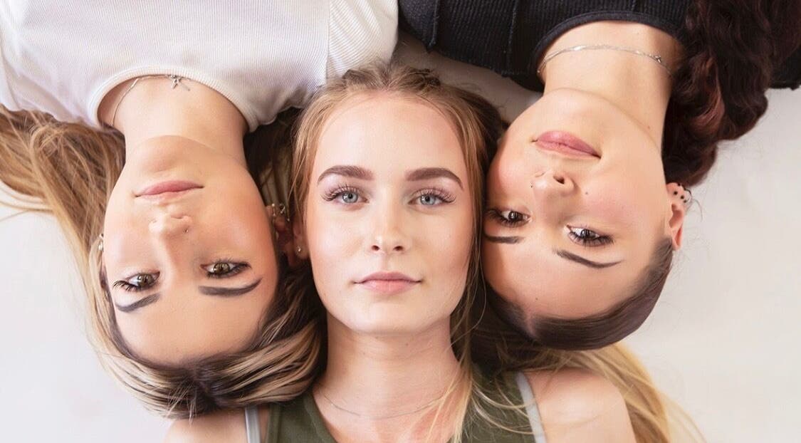 Three women showcase beauty at Lush Lash Ariana, Kapiti, Wellington, NZ, highlighting natural elegance.