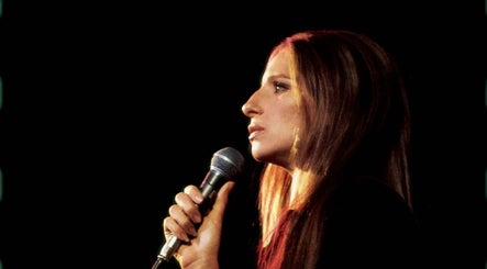 Woman performing on stage at Aesthetics in Cape Town, Western Cape, ZA, holding a microphone.