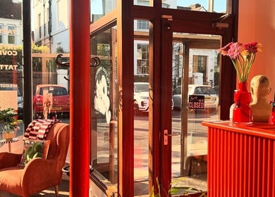 Chic interior of Old Flame Tattoo Removal, Portsmouth, England, bathed in warm natural light.