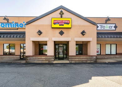 Exterior view of Fantasy Sports Cuts at Fayetteville, Arkansas, US, featuring a vibrant storefront entrance.