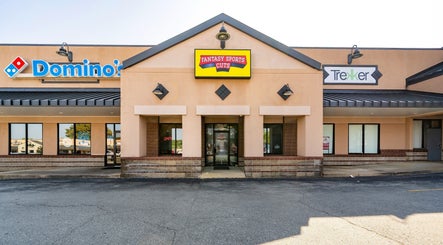 Exterior view of Fantasy Sports Cuts at Fayetteville, Arkansas, US, featuring a vibrant storefront entrance.