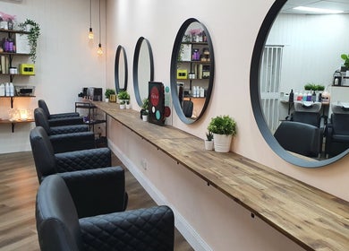 Modern salon setup at S&R Hair Studio, Hassall Grove, New South Wales, AU, featuring elegant mirrors and styling chairs.