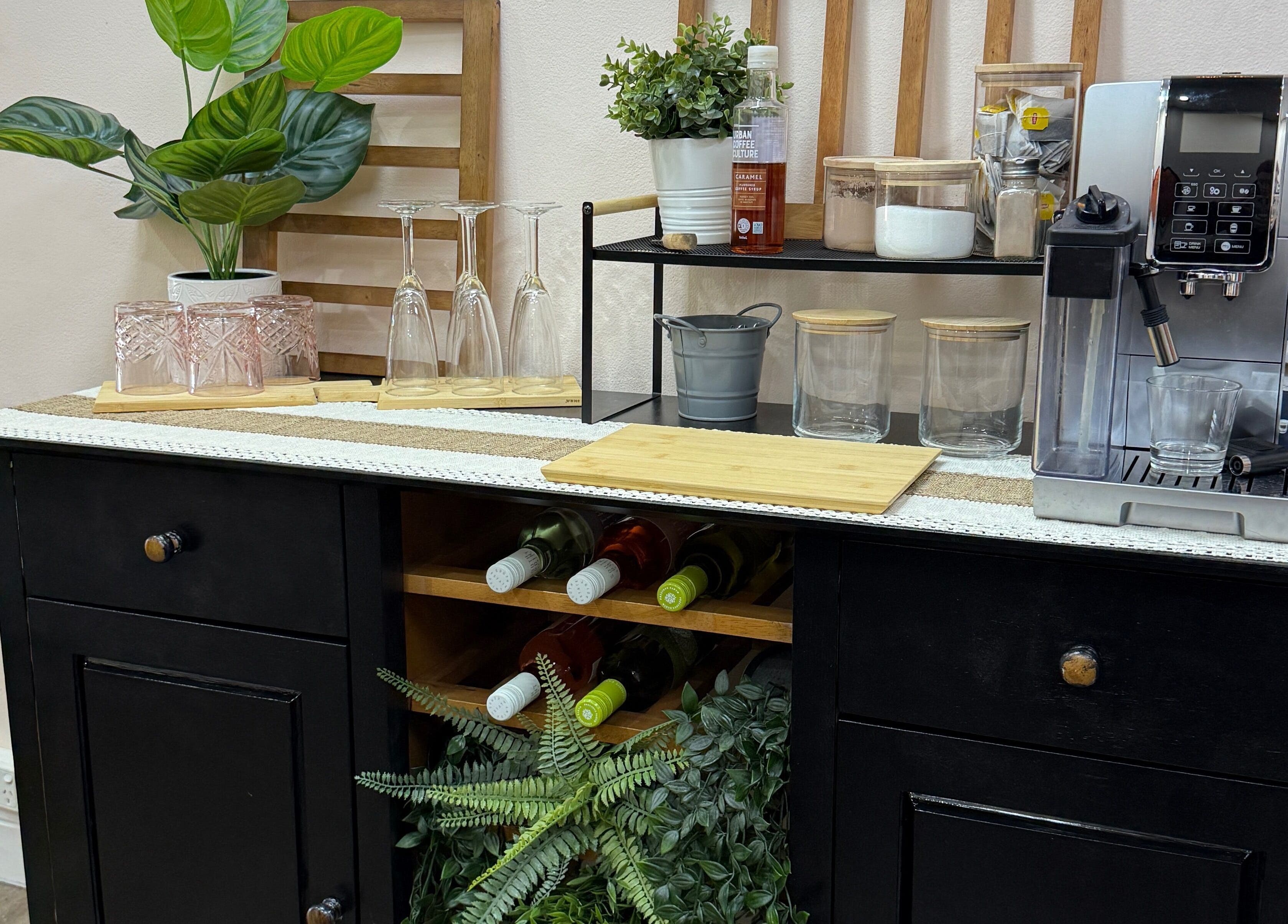 S&R Hair Studio in Hassall Grove, NSW, features a stylish coffee station with greenery, glasses, and a coffee machine.