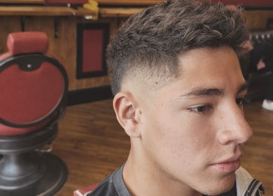Young man with a stylish fade haircut at Kings Barbers, Horsham, England, GB.