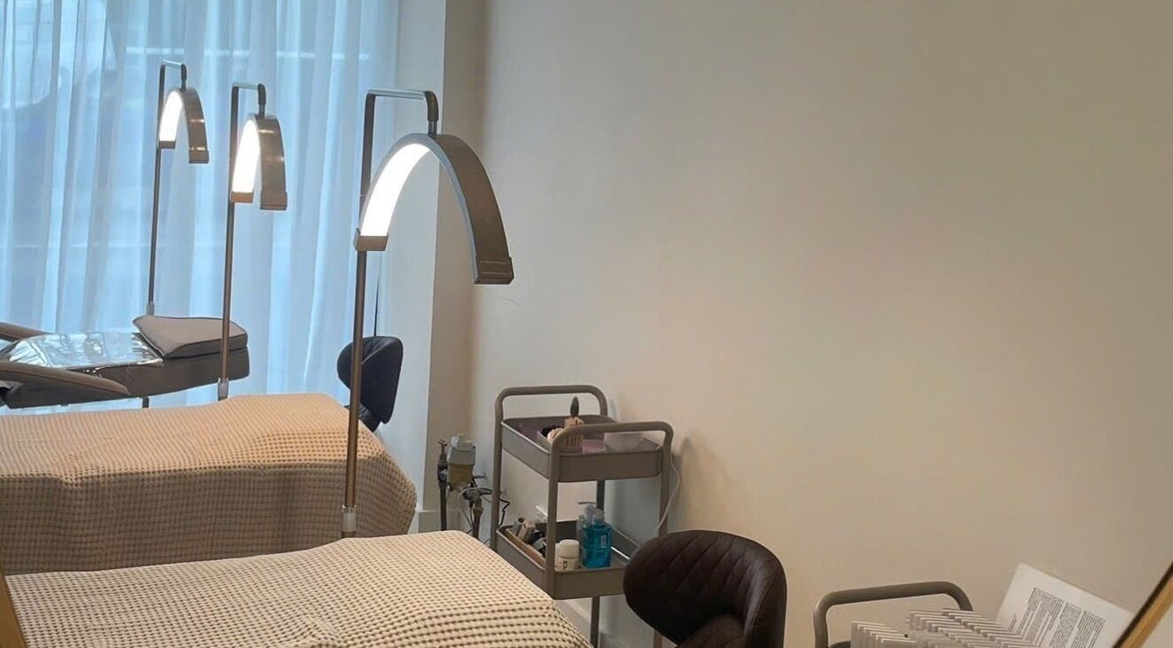Treatment beds at The Oasis Cosmetic Tattoo Malvern in Melbourne, Victoria, AU with lamps and equipment.